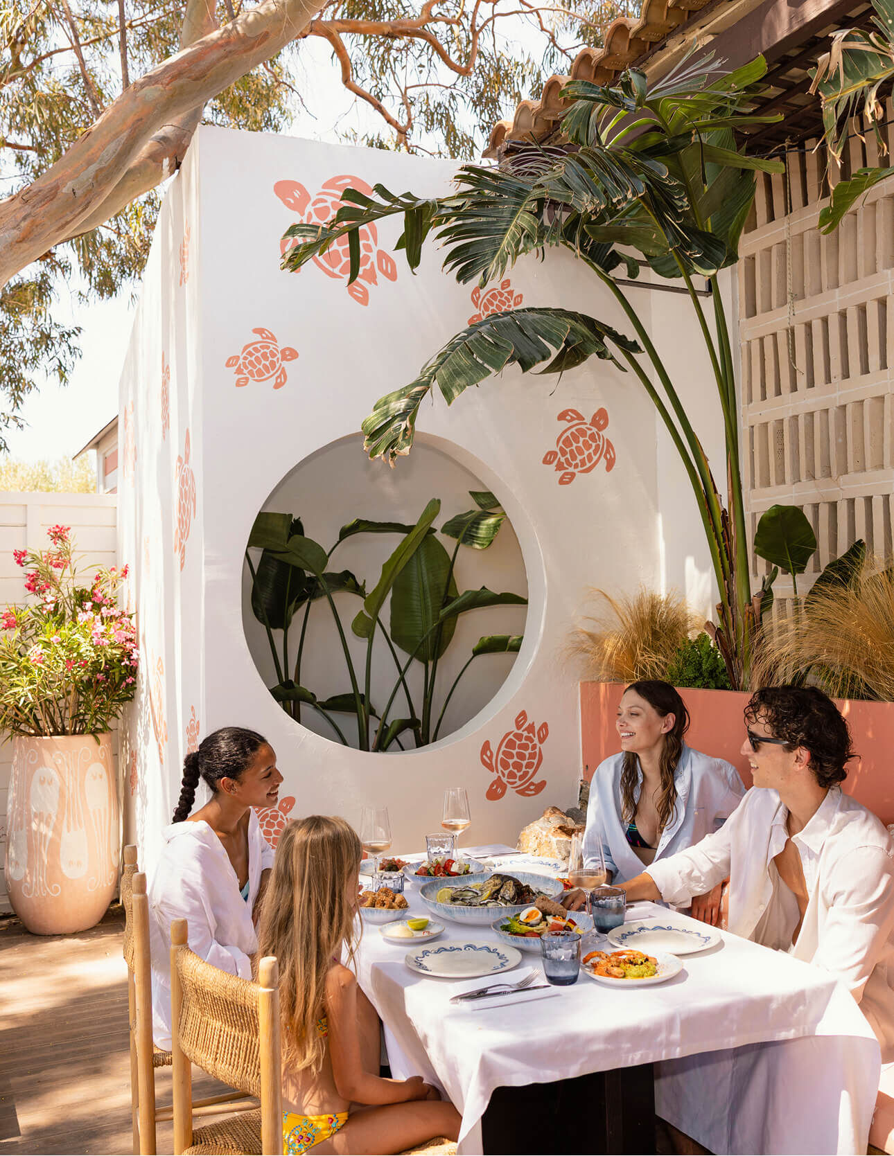 Group of friends enjoying a seafood lunch outdoors.